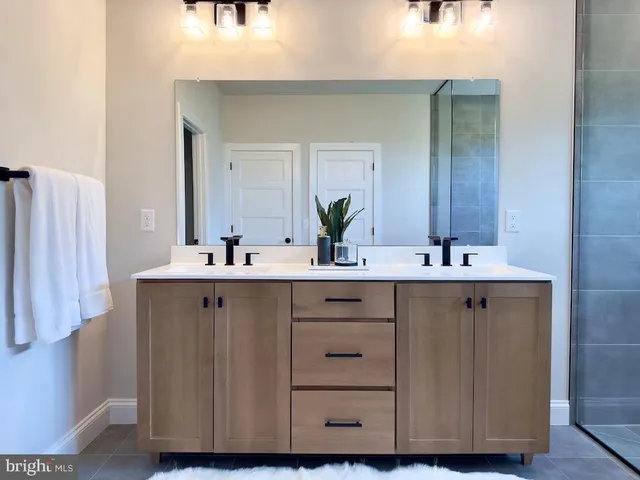 a bathroom with a glass shower door