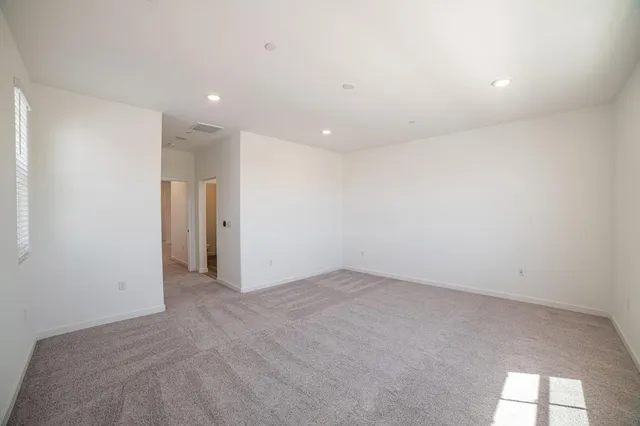 a spacious bathroom with double vanity and a large mirror