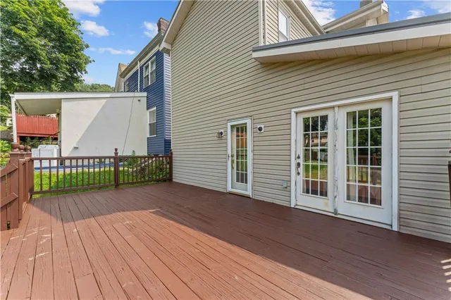 a view of a wooden deck with a yard