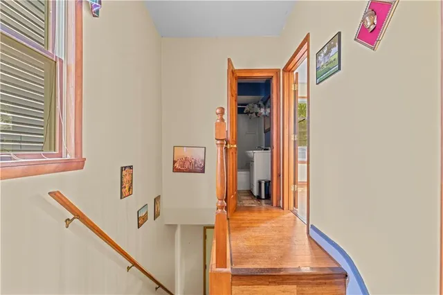 a hallway with sliding door and kitchen view