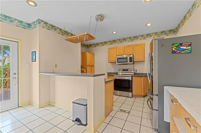 a kitchen with stainless steel appliances granite countertop a refrigerator and a stove top oven