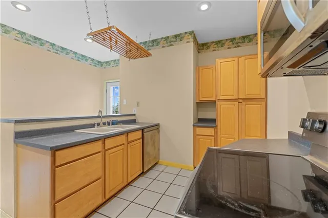 a kitchen with a sink appliances and cabinets