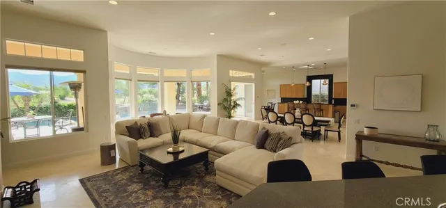 a kitchen with stainless steel appliances kitchen island granite countertop a refrigerator a stove a sink and a microwave