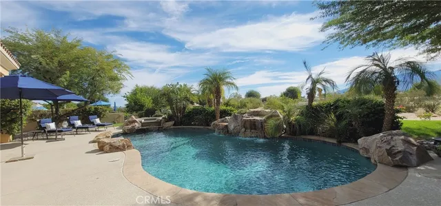 swimming pool view with a seating space