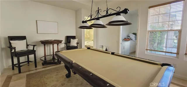 a view of a patio with table and chairs and potted plants