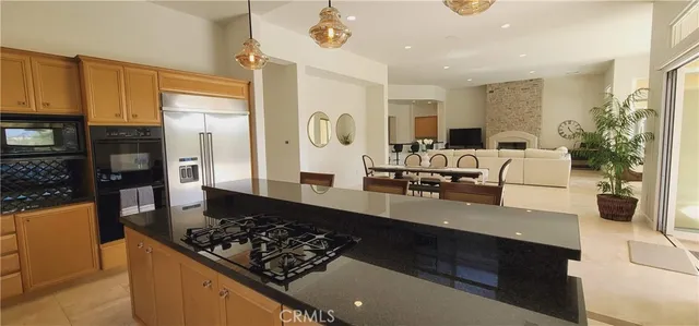 a view of patio with a table and chairs and potted plants