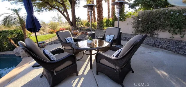 a view of backyard with outdoor seating a patio and plants