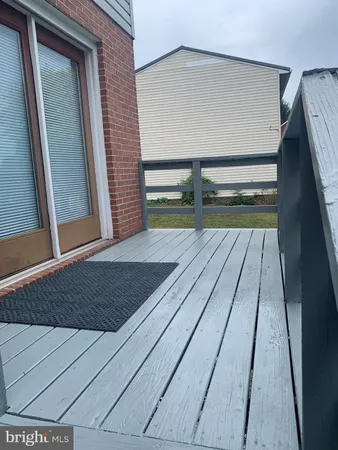 a view of backyard with wooden floor and fence