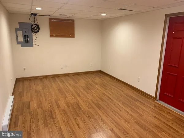 a view of a room with wooden floor
