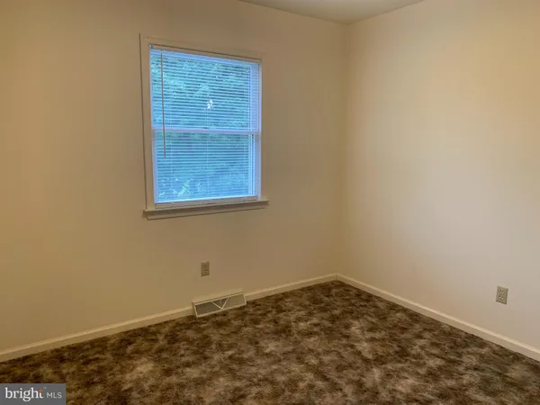 an empty room with wooden floor