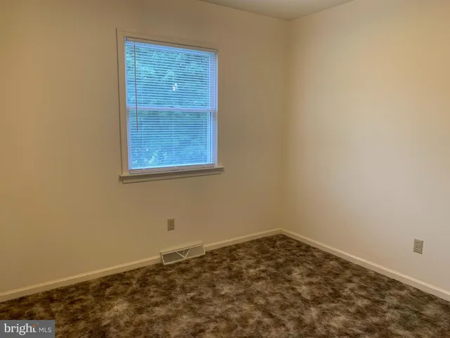 an empty room with wooden floor
