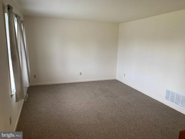 a view of an empty room and a window