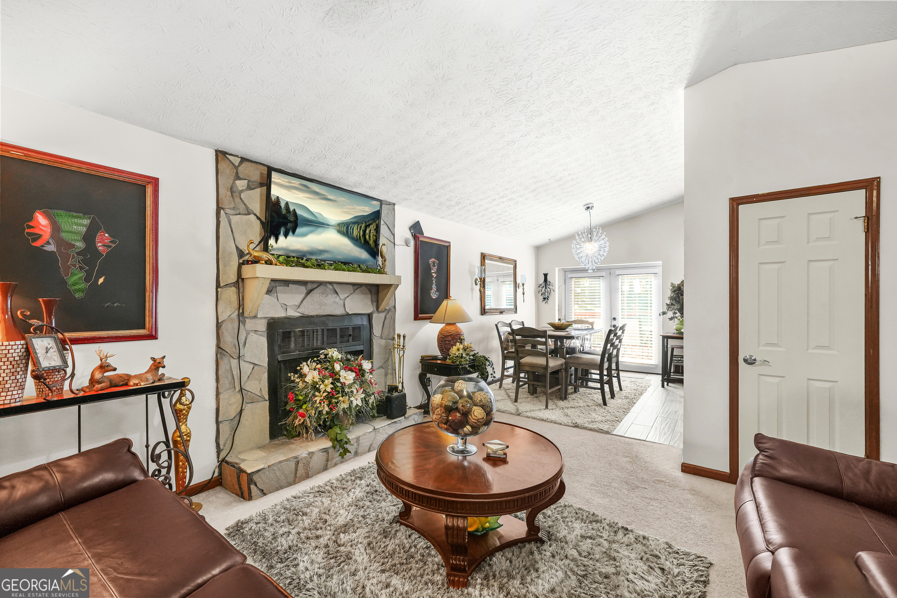 3111 Octavia Lane Snellville, GA 30039 - Photo 11 of 42 a living room with furniture a fireplace and flat screen tv