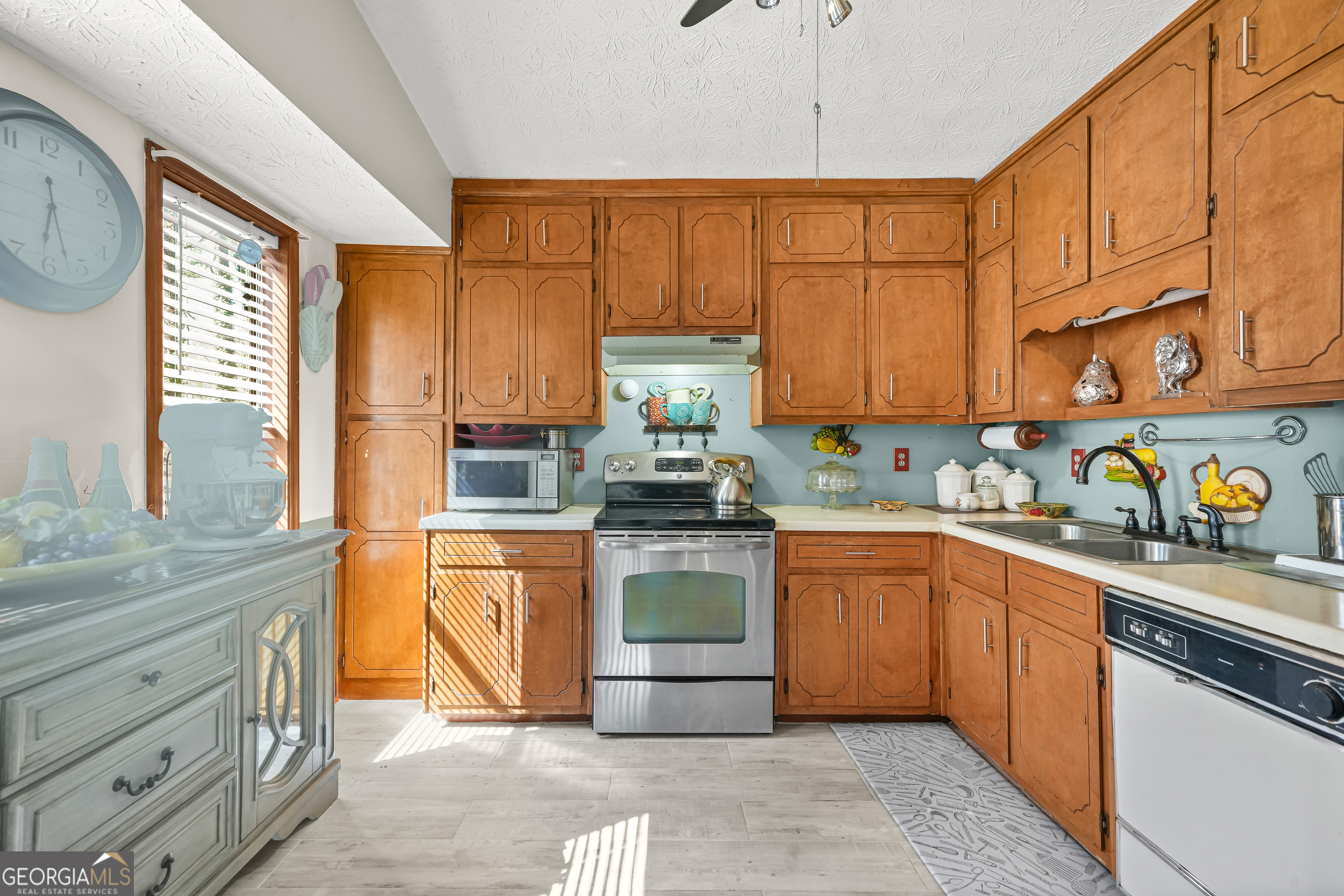 3111 Octavia Lane Snellville, GA 30039 - Photo 14 of 42 a kitchen with stainless steel appliances granite countertop a stove sink and cabinets