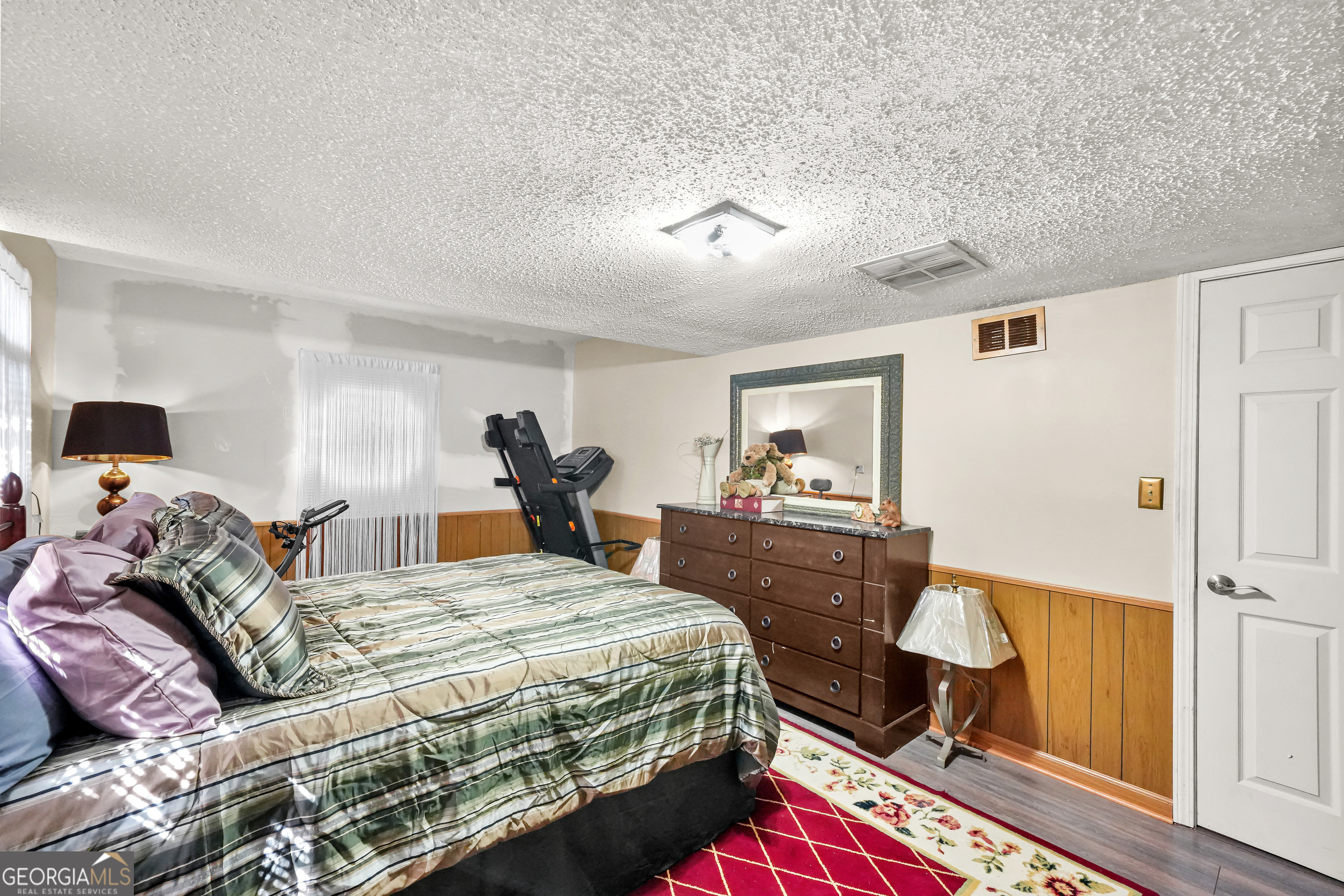 3111 Octavia Lane Snellville, GA 30039 - Photo 19 of 42 a bedroom with a bed and wooden floor
