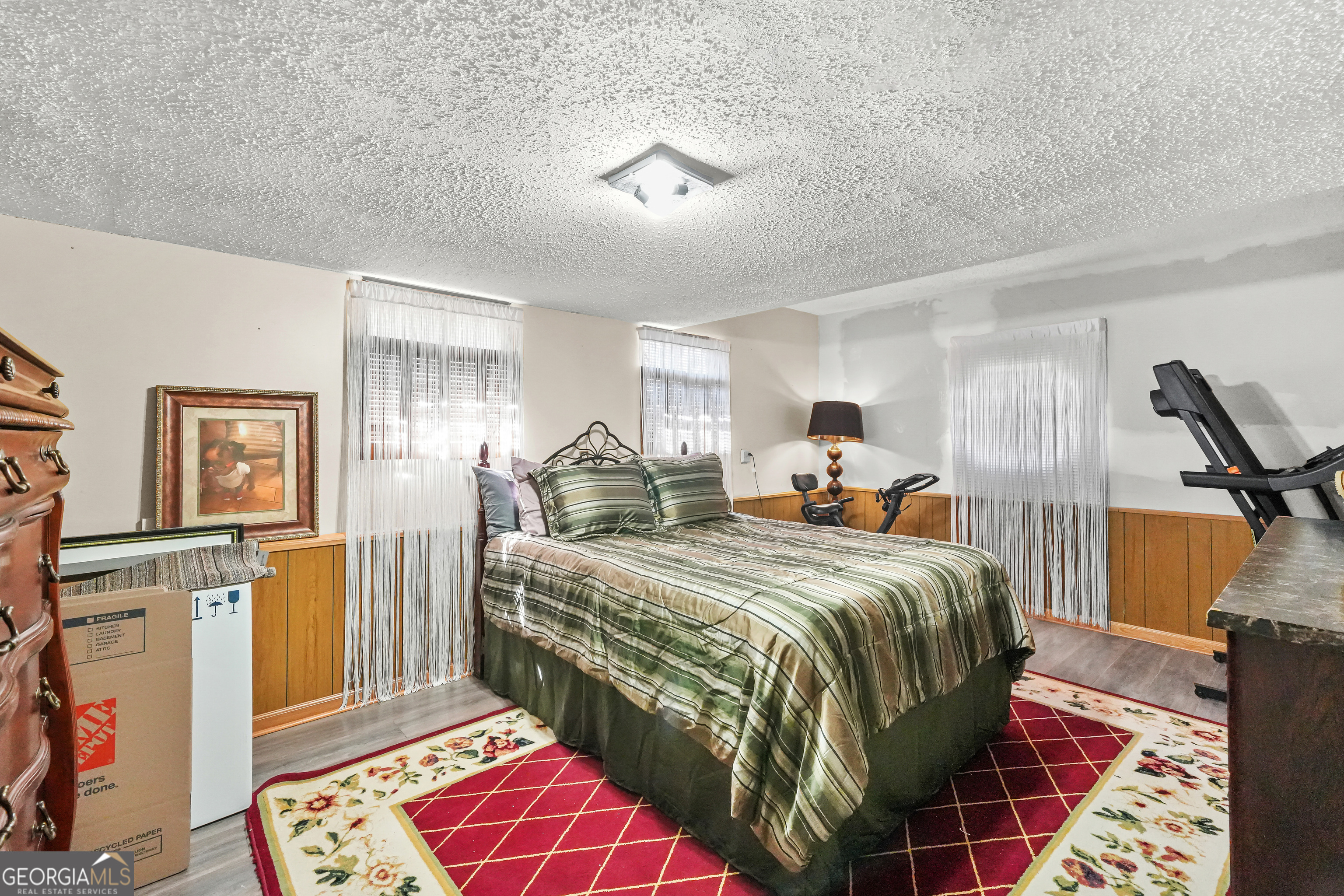 3111 Octavia Lane Snellville, GA 30039 - Photo 20 of 42 a bedroom with a bed and wooden floor