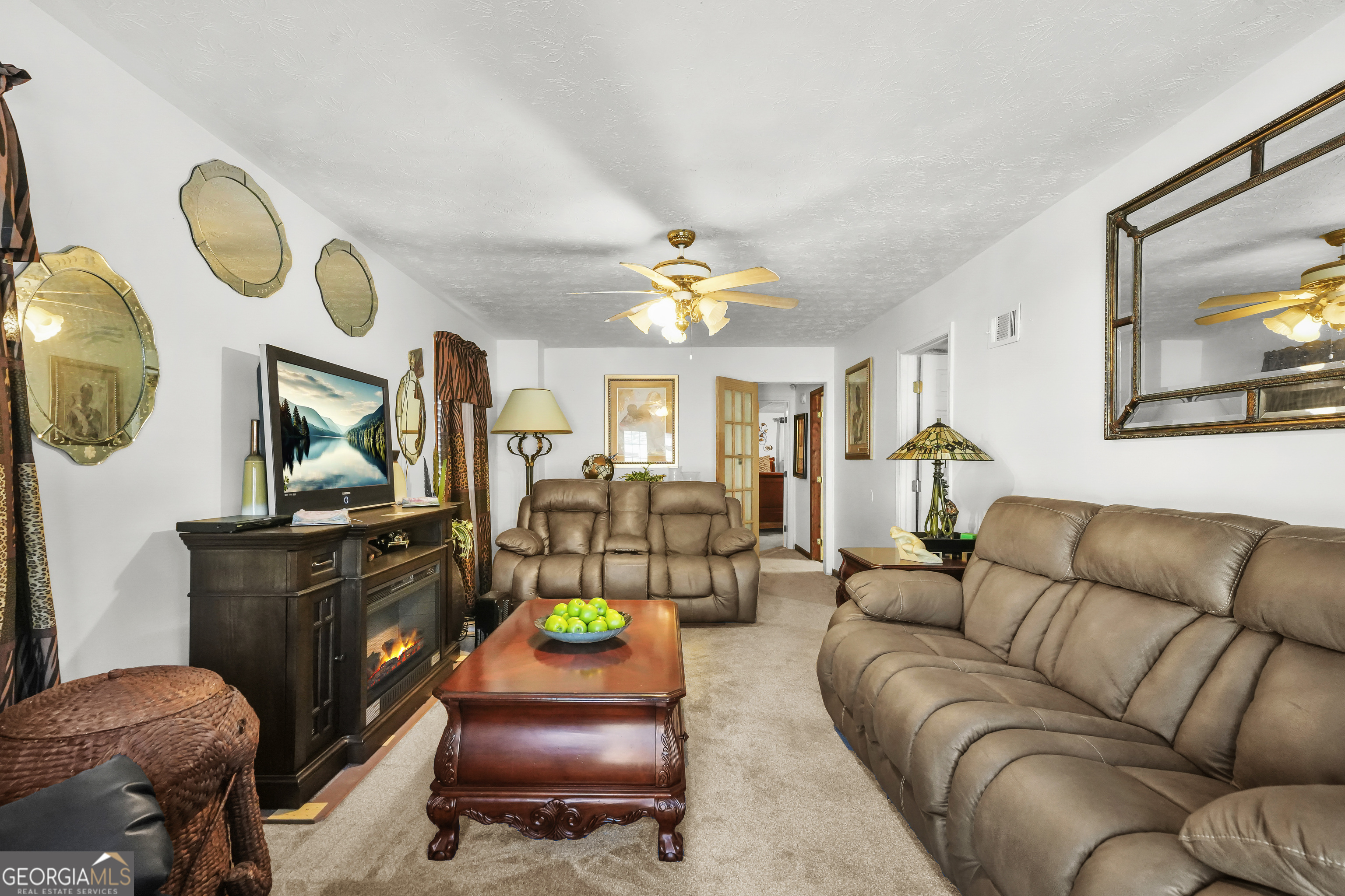 3111 Octavia Lane Snellville, GA 30039 - Photo 21 of 42 a living room with furniture a chandelier and a mirror
