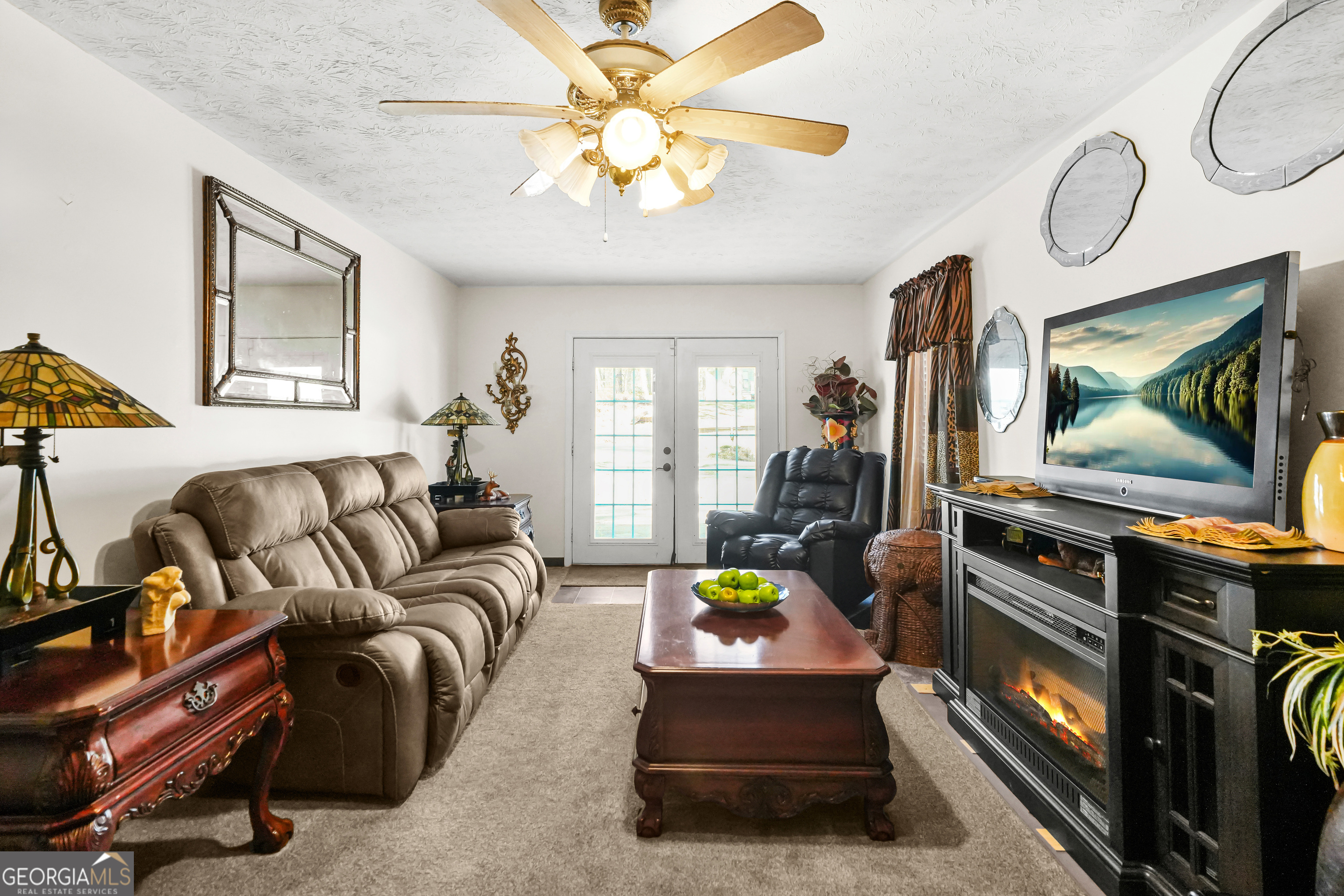 3111 Octavia Lane Snellville, GA 30039 - Photo 22 of 42 a living room with furniture a flat screen tv and a floor to ceiling window