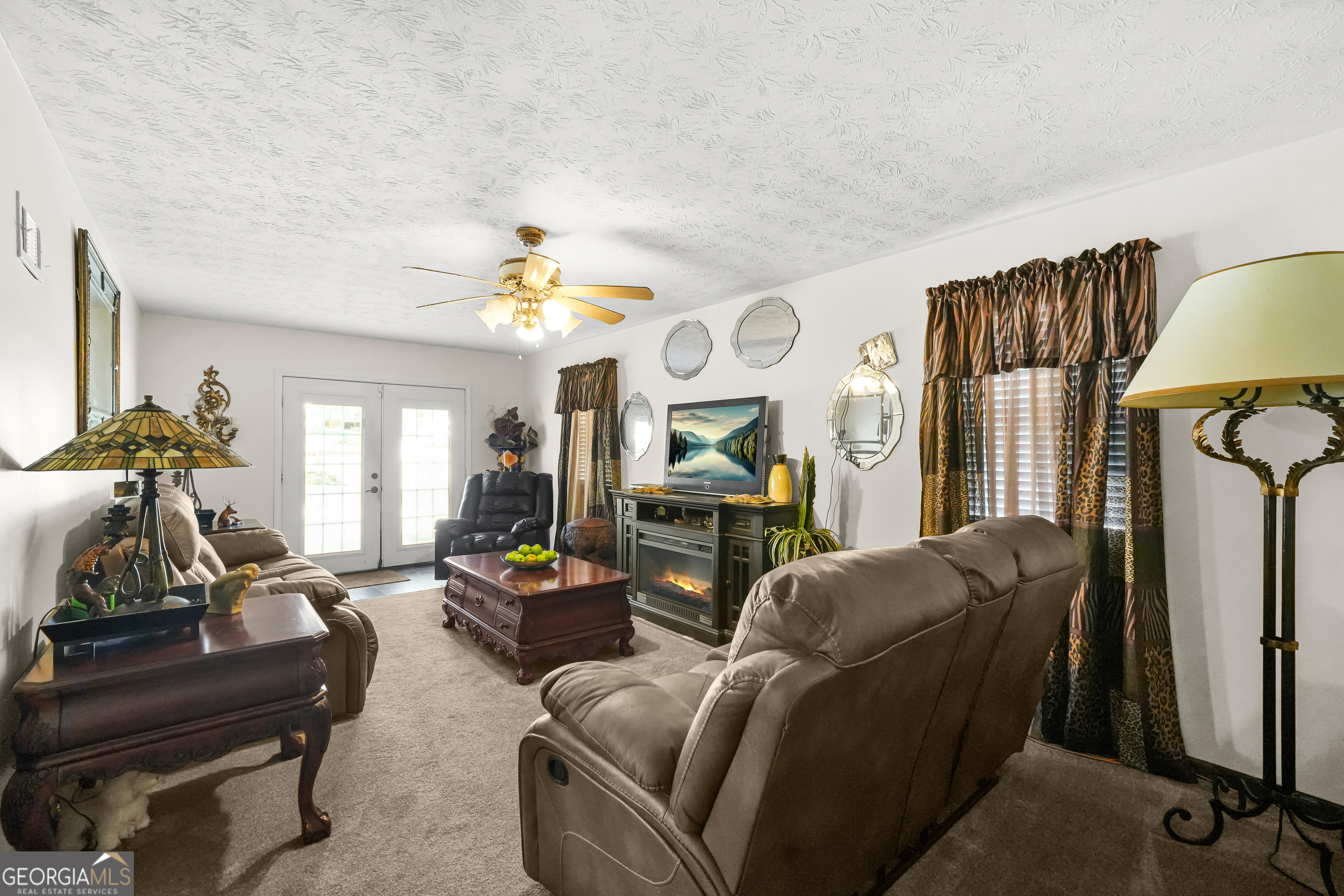 3111 Octavia Lane Snellville, GA 30039 - Photo 23 of 42 a living room with furniture a fireplace and a flat screen tv
