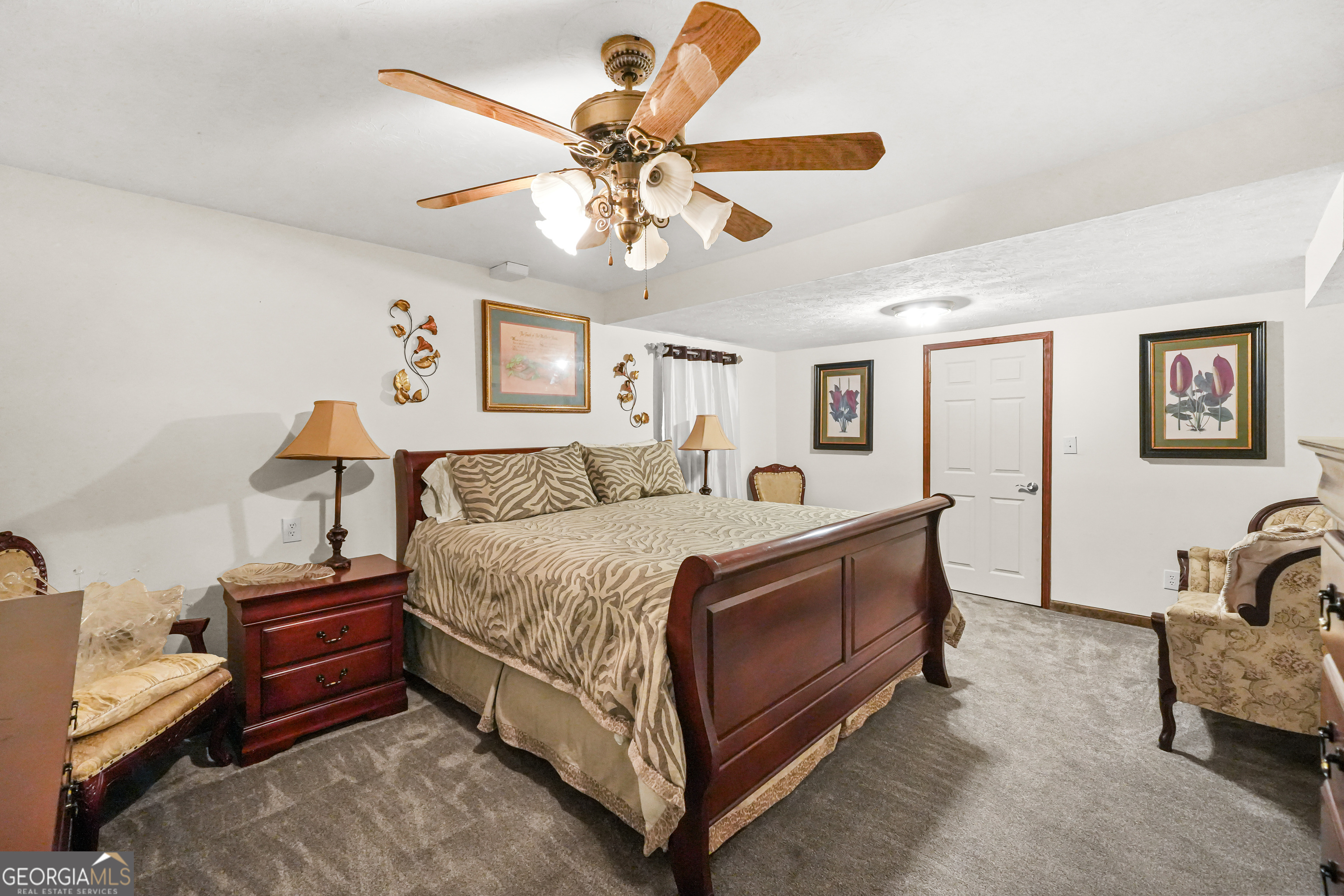 3111 Octavia Lane Snellville, GA 30039 - Photo 24 of 42 a spacious bedroom with a bed and a chandelier