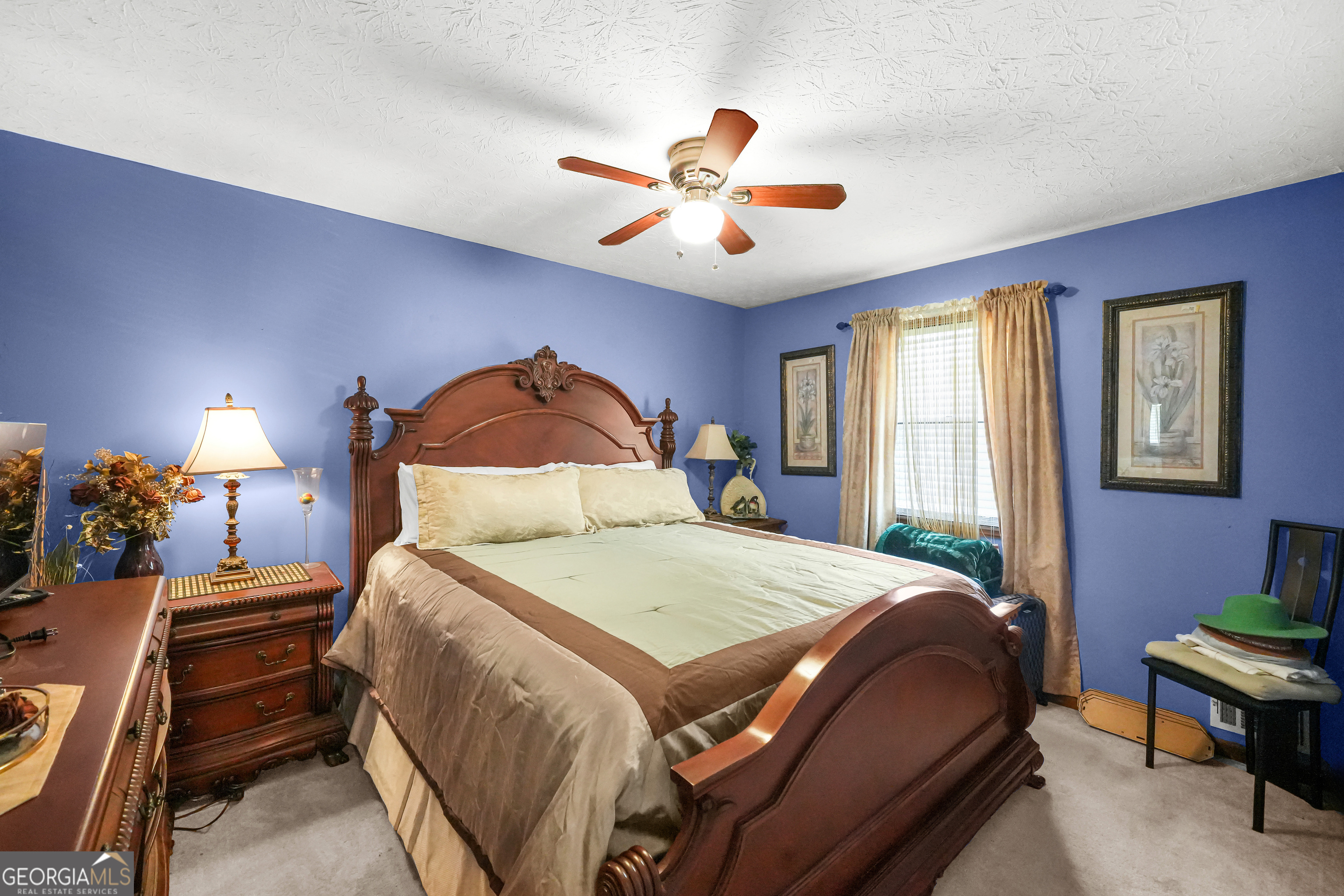 3111 Octavia Lane Snellville, GA 30039 - Photo 29 of 42 a bedroom with a bed and a chandelier