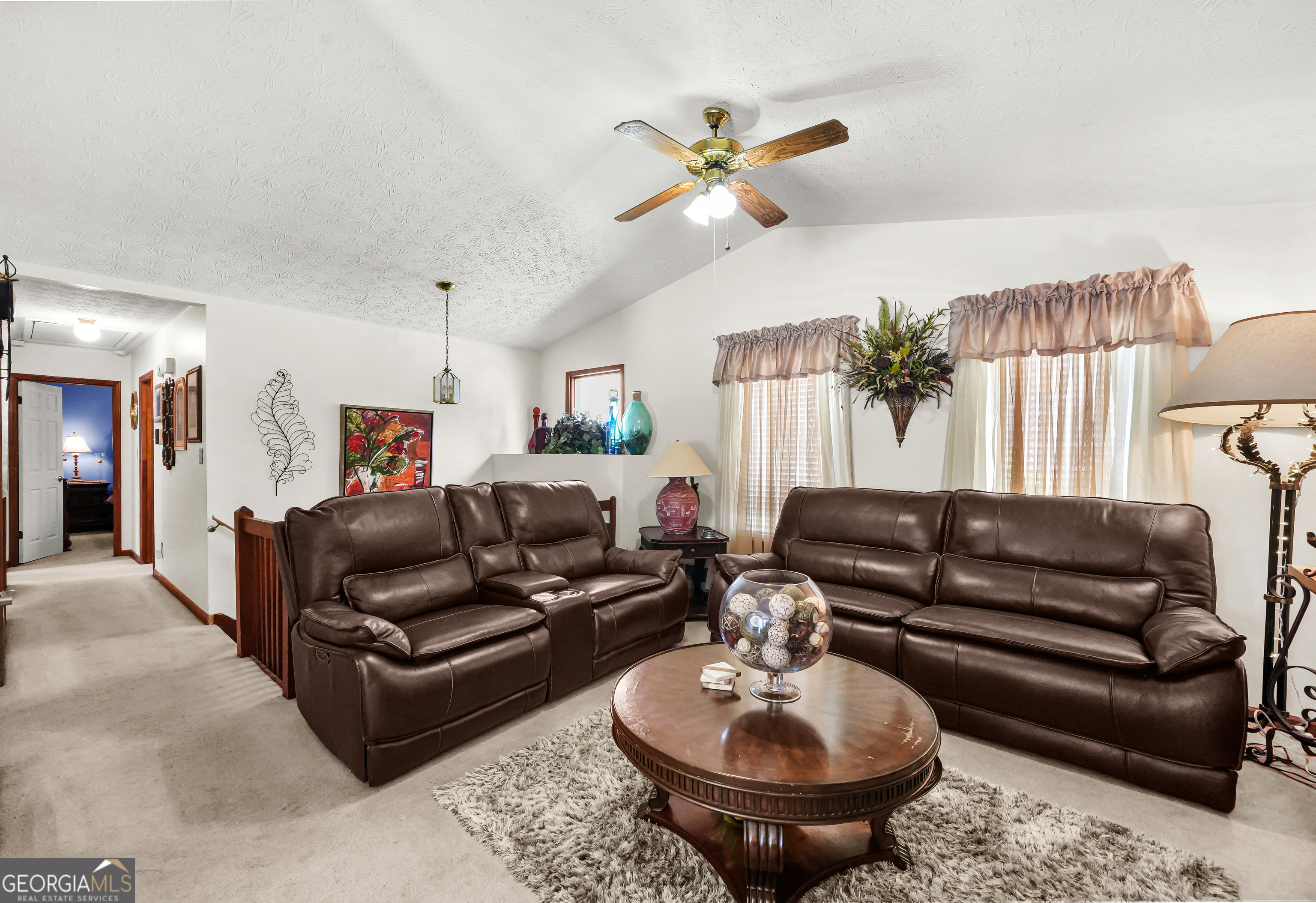 3111 Octavia Lane Snellville, GA 30039 - Photo 9 of 42 a living room with furniture a rug and a chandelier