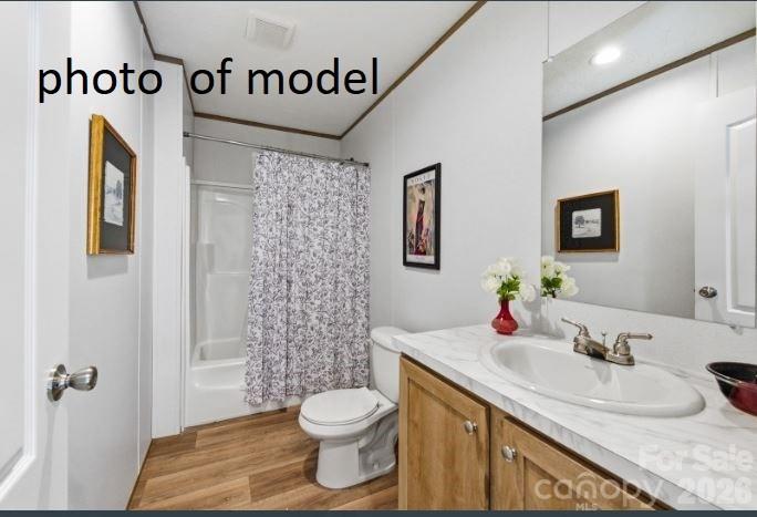 877 Biggerstaff Loop, Unit E Nebo, NC 28761 - Photo 14 of 26 a bathroom with a granite countertop sink and a mirror