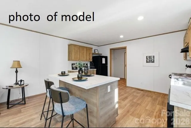 a view of kitchen island with furniture and wooden floor