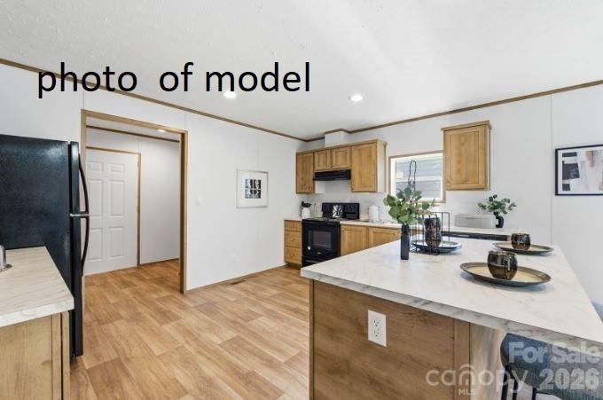 877 Biggerstaff Loop, Unit E Nebo, NC 28761 - Photo 6 of 26 a kitchen with sink refrigerator and stove