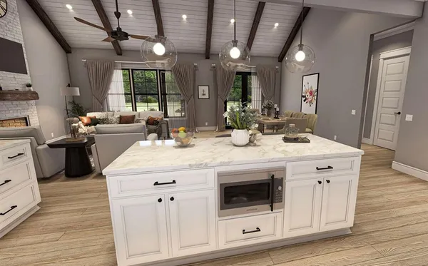 a kitchen with kitchen island granite countertop a sink and white cabinets with wooden floor