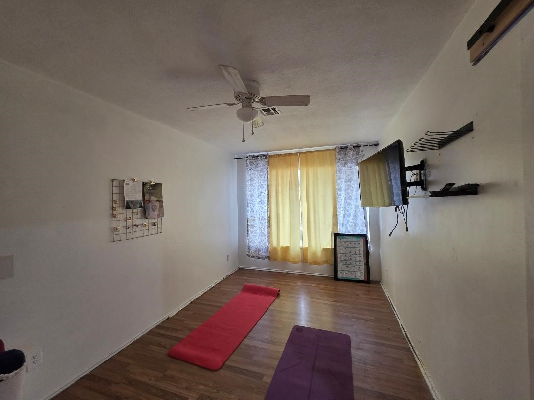 2414 Goldenrod Street Highlands, TX 77562 - Photo 12 of 22 a bedroom with a bed and a window