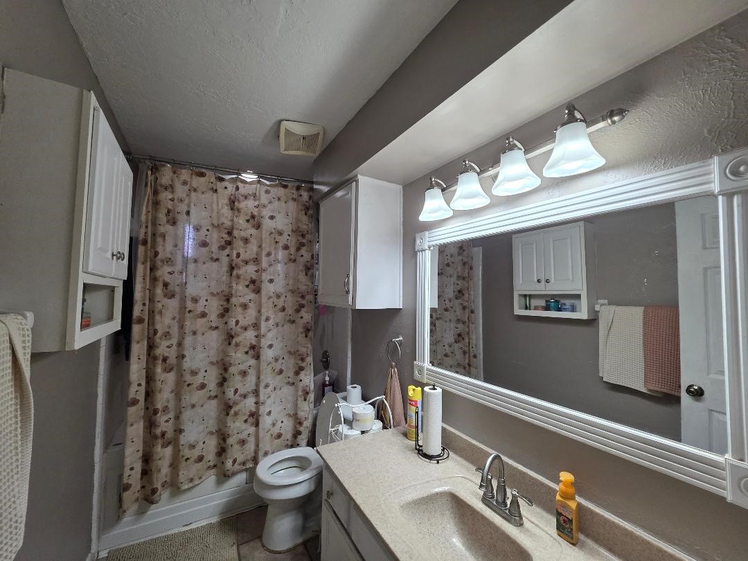 2414 Goldenrod Street Highlands, TX 77562 - Photo 13 of 22 a bathroom with a sink toilet and shower