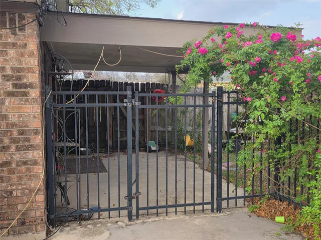 a view of a house with wooden fence