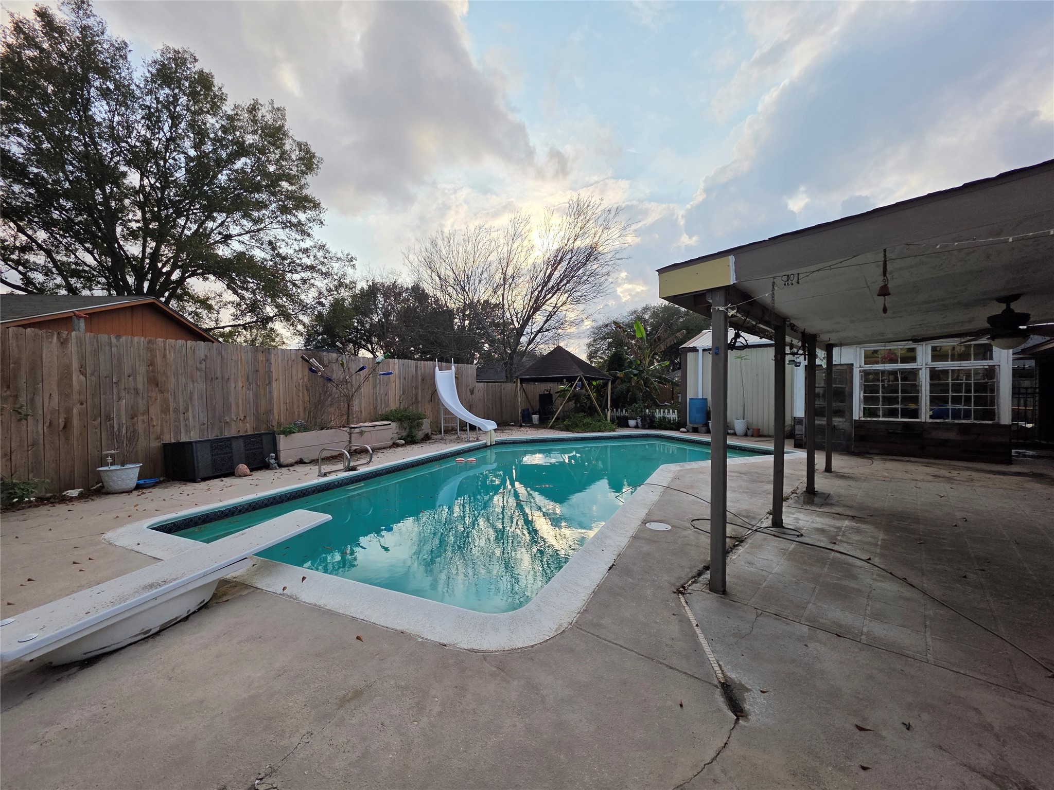 2414 Goldenrod Street Highlands, TX 77562 - Photo 18 of 22 a swimming pool with outdoor seating and yard