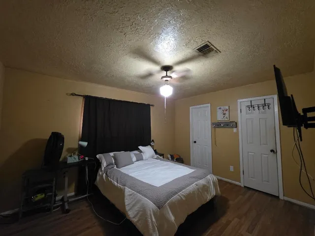 a bedroom with a bed and a chandelier