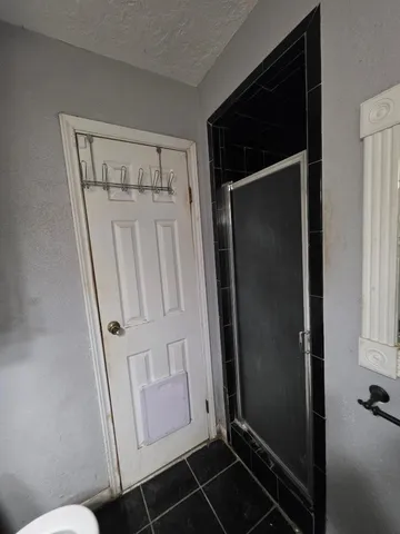 a bathroom with a toilet and a shower