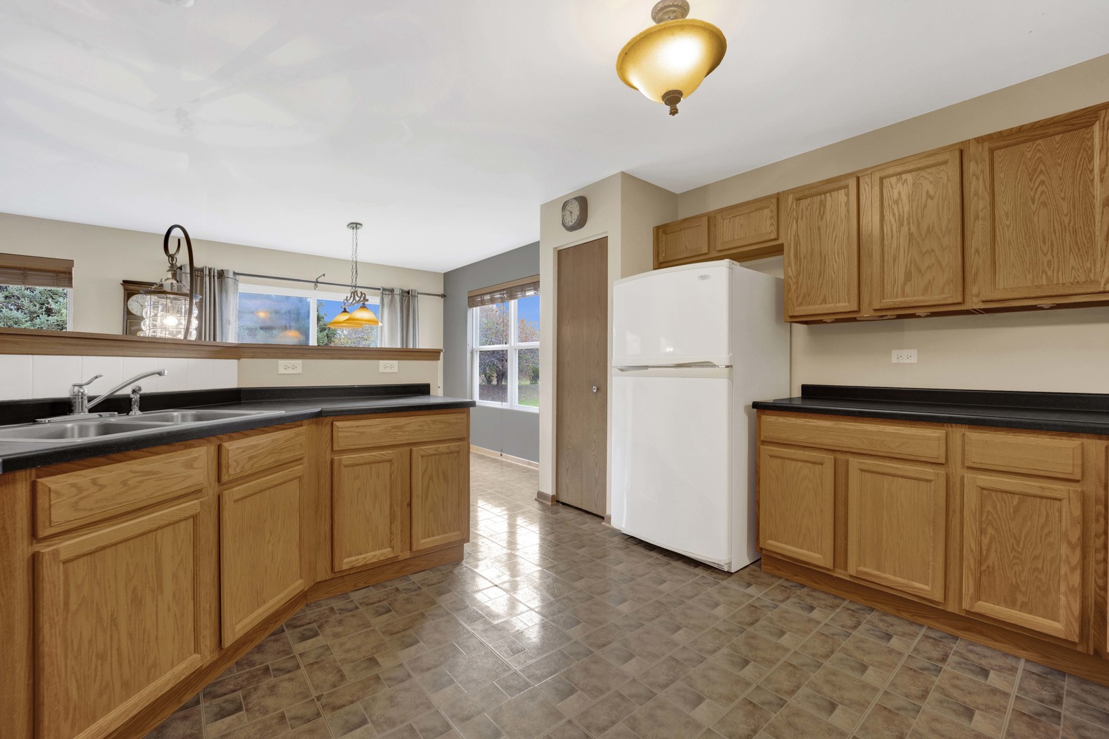 3904 Stockton Drive Joliet, IL 60421 - Photo 12 of 33 a kitchen with stainless steel appliances granite countertop a refrigerator sink and cabinets