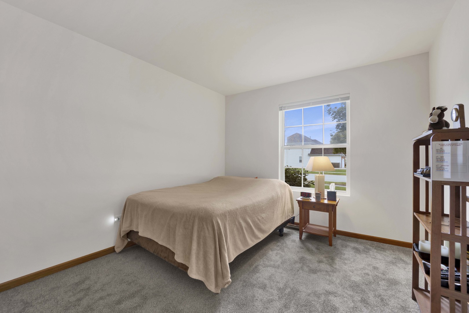3904 Stockton Drive Joliet, IL 60421 - Photo 25 of 33 a bedroom with a bed and a book shelf