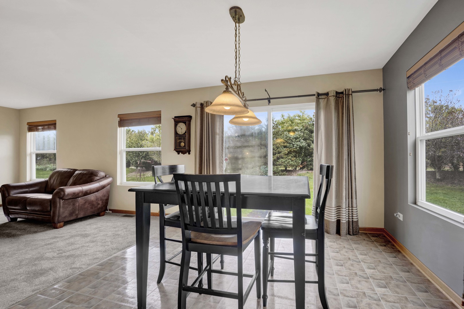 3904 Stockton Drive Joliet, IL 60421 - Photo 10 of 33 a dining room with furniture a chandelier and wooden floor