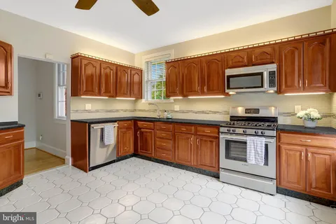 a bathroom with a sink and mirror with toilet