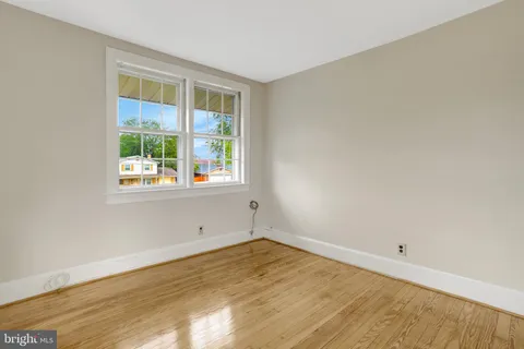 a view of backyard with outdoor seating and trees