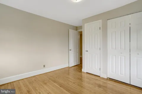 a patio with glass top table and chairs