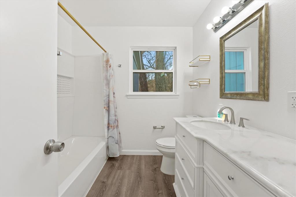 9521 Dalrock Road Rowlett, TX 75089 - Photo 11 of 38 a bathroom with a sink a toilet and shower