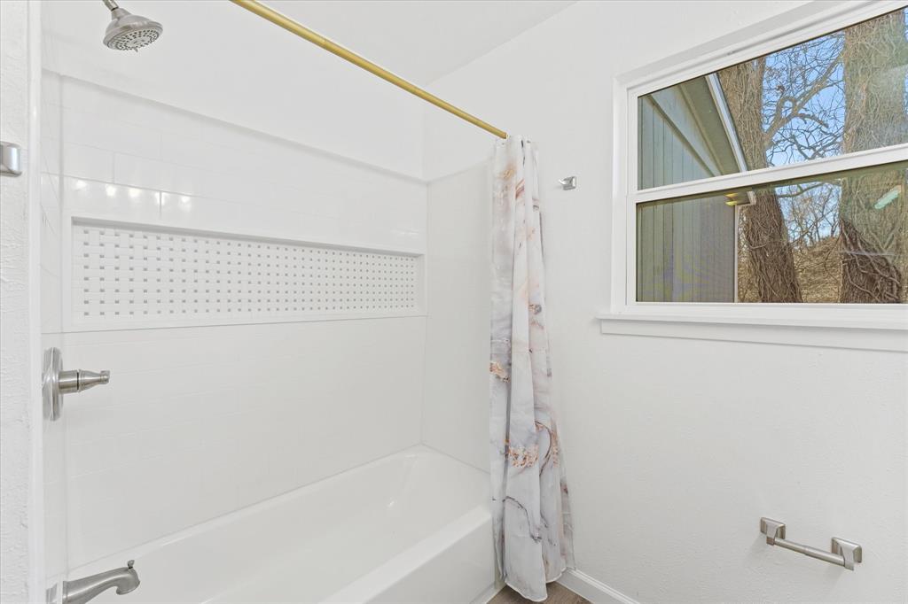9521 Dalrock Road Rowlett, TX 75089 - Photo 12 of 38 a bathroom with a bathtub and a shower