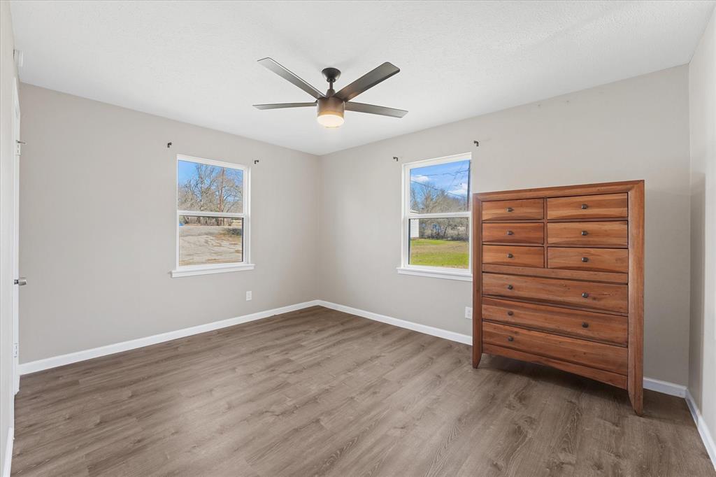 9521 Dalrock Road Rowlett, TX 75089 - Photo 15 of 38 a view of room with window and a ceiling fan
