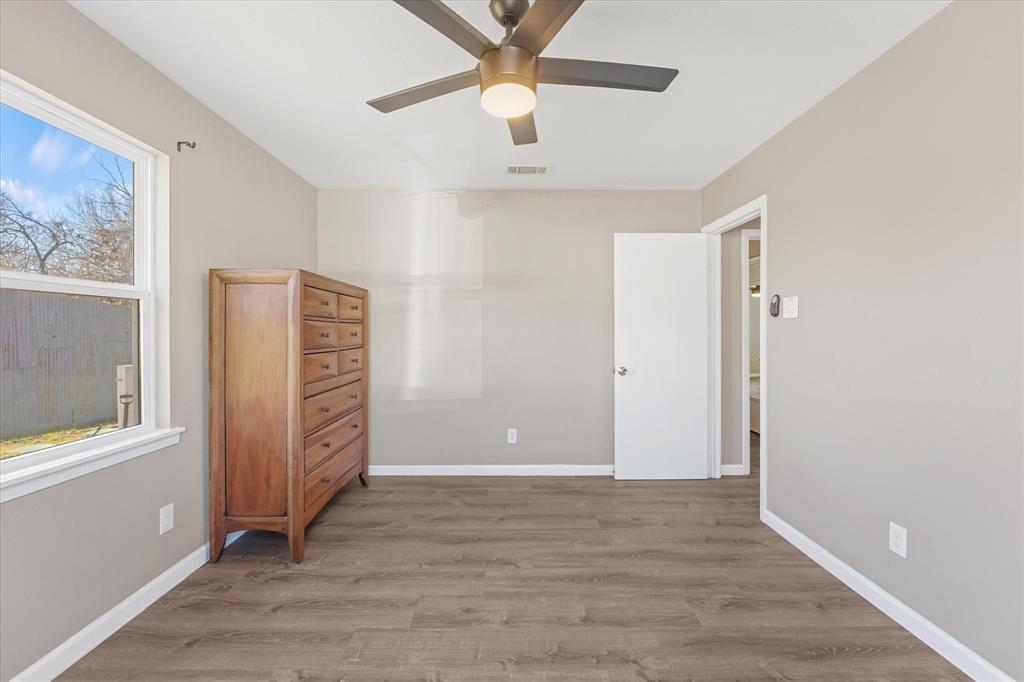 9521 Dalrock Road Rowlett, TX 75089 - Photo 16 of 38 wooden floor in an empty room with a window
