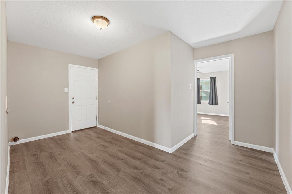9521 Dalrock Road Rowlett, TX 75089 - Photo 17 of 38 an empty room with wooden floor and windows