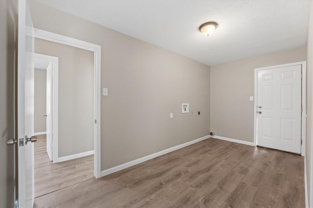 9521 Dalrock Road Rowlett, TX 75089 - Photo 18 of 38 an empty room with wooden floor