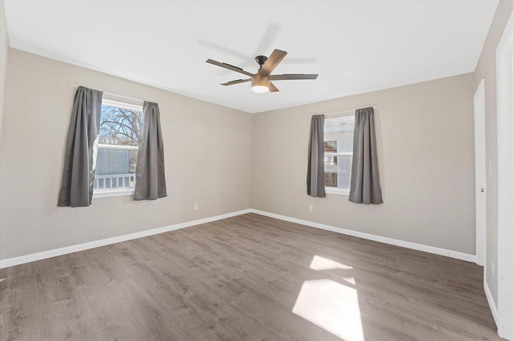9521 Dalrock Road Rowlett, TX 75089 - Photo 19 of 38 a view of an empty room with window and wooden floor