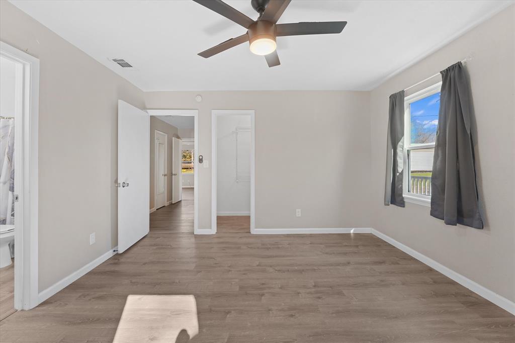 9521 Dalrock Road Rowlett, TX 75089 - Photo 21 of 38 wooden floor in an empty room with a window